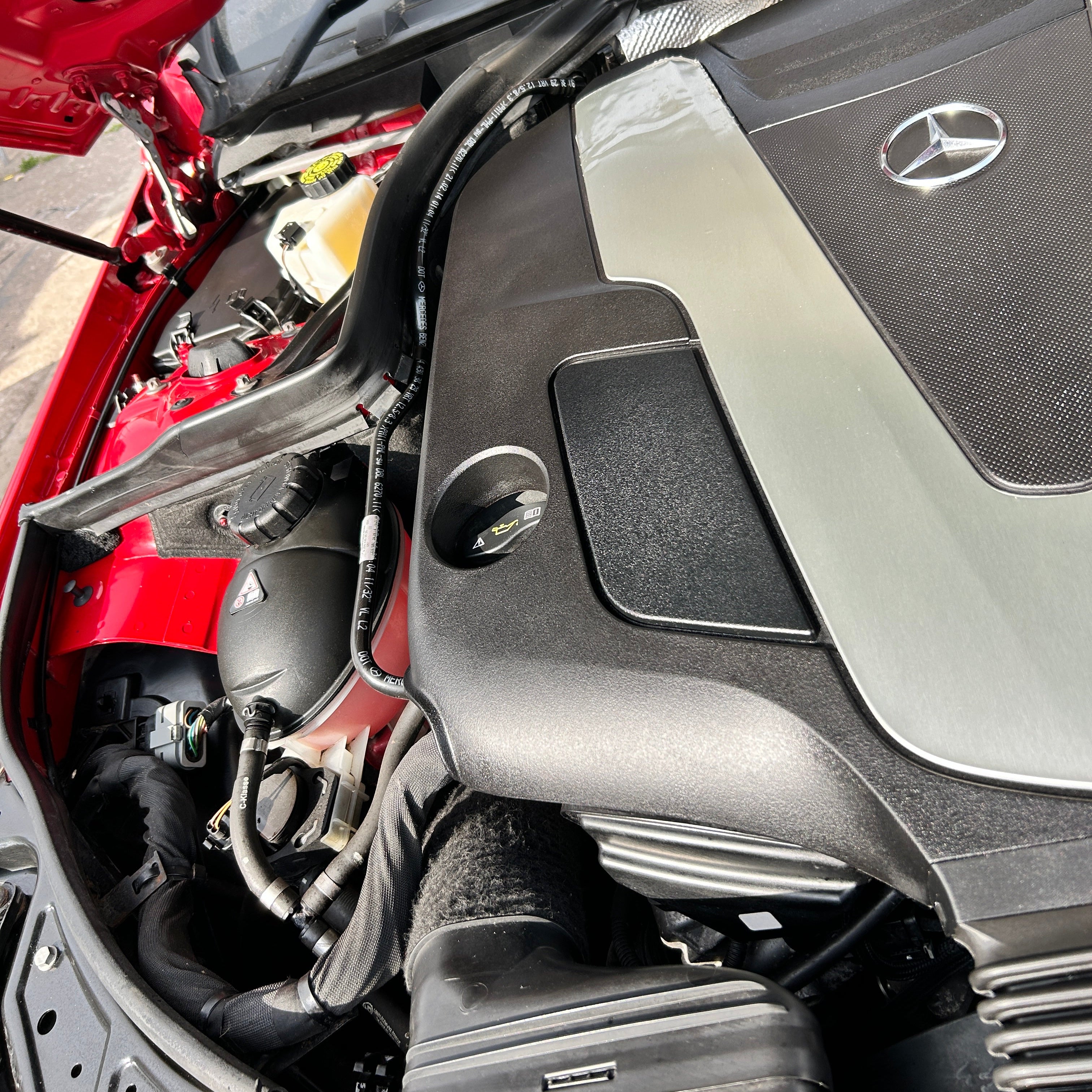 Close-up of a car engine with Mercedes-Benz logo