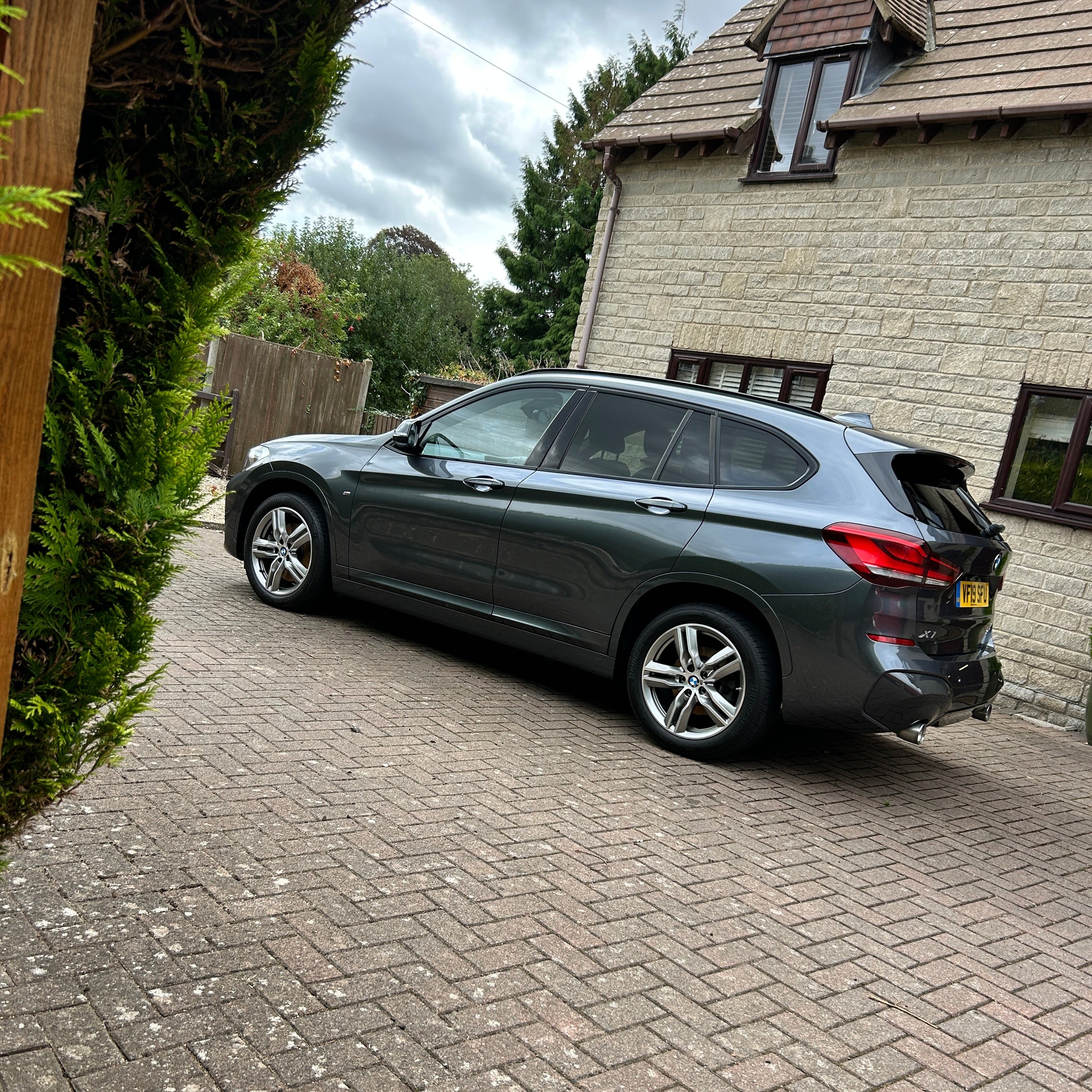 Car parked on a driveway next to a house